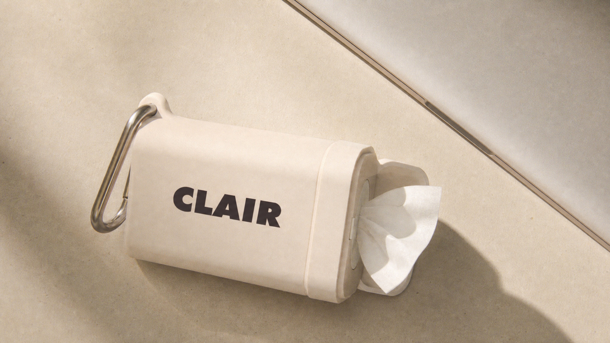 CLAIR case in Cloud lying on its side in warm sunlight, a wipe pulled from the end