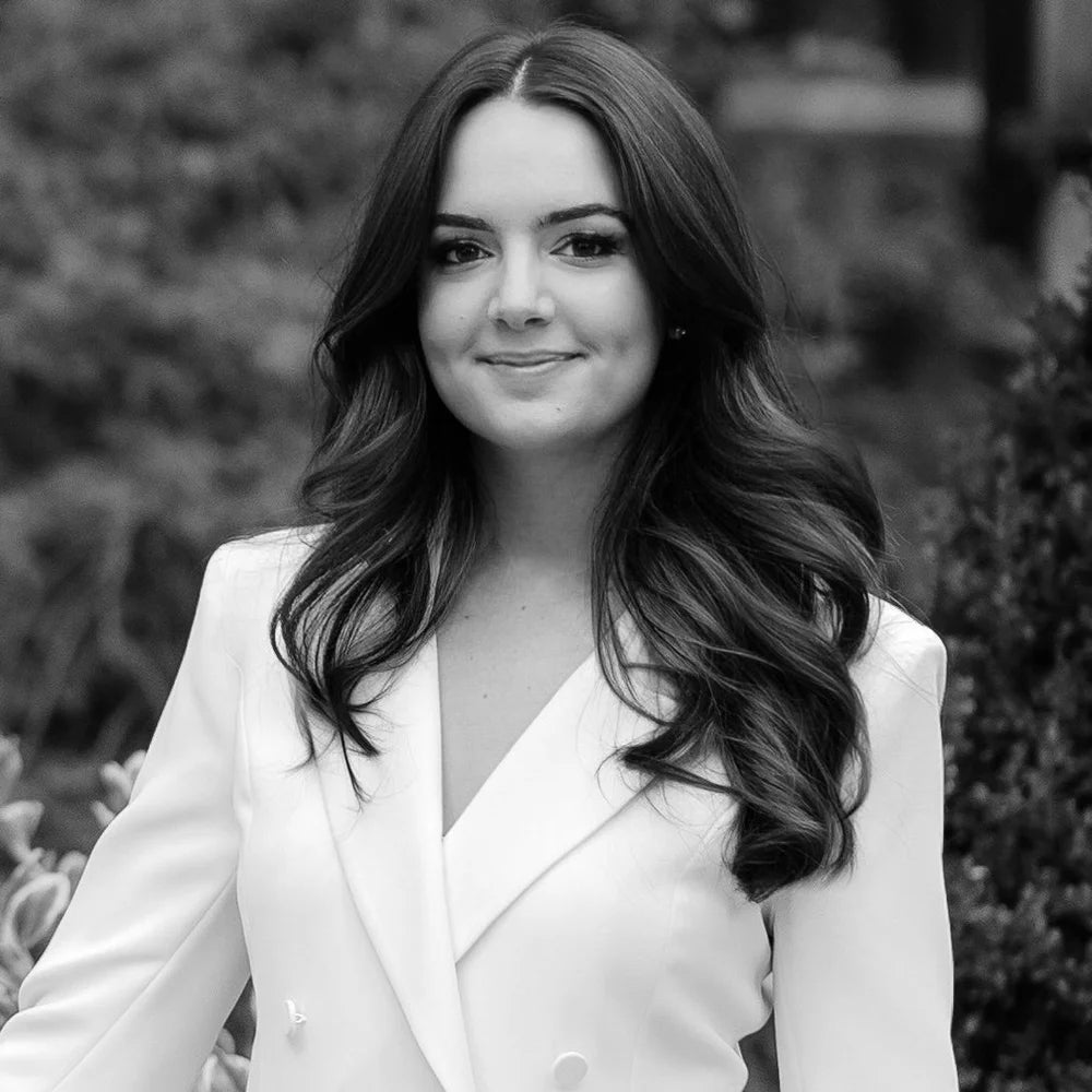 Michelle of CLAIR, black-and-white portrait in a white blazer